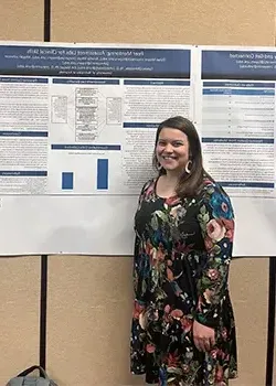 a student presents a poster at a conference